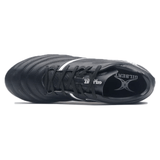A top-view of the Gilbert Sidestep X20 8S Power SG - Black/White reveals a black athletic rugby boot with white accents, showcasing the "Gilbert" brand name on the insole, engineered for power and performance on soft ground.