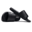 Two black Gilbert Slide Sandals are displayed; one standing upright and the other lying on its side, showcasing the brand name "Gilbert" on the sole. Crafted from quick-drying material with plush cushioning, they offer both comfort and convenience.