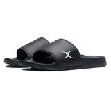 A pair of Gilbert Slide Sandals - Black, featuring plush cushioning and a white Gilbert logo on the strap.