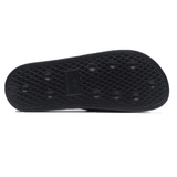 The image shows the sole of a black shoe featuring round grips and a textured pattern for traction, similar to the design found in Gilbert Slide Sandals - Black by Gilbert.
