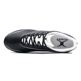 Top view of a black cycling shoe with a white interior, featuring the brand name "Gilbert" inside. The Gilbert Cage Torq MSX FG - Black/White shoe has a lace-up closure, perforations for ventilation, and a multi-surface sole for versatile use.