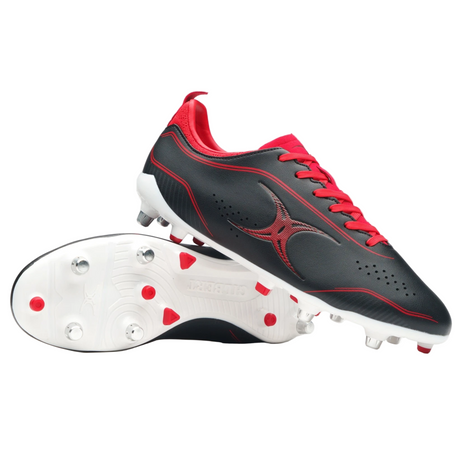 A pair of Gilbert Cage Torq 6S SG rugby boots in black and red, featuring white soles with metal studs; one boot stands upright while the other lies on its side showing the sole.