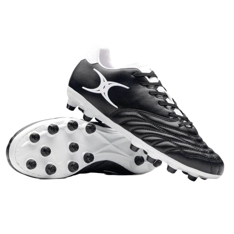 A pair of Gilbert Sidestep Icon MSX soccer cleats in black and white, featuring a synthetic leather upper and molded studs, shown side by side on a white background.