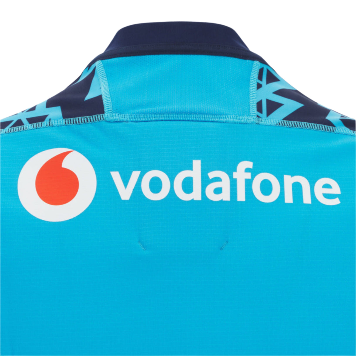 Close-up of the back of the Scotland 25/26 Sky Training Jersey by Macron, a blue rugby top featuring the Vodafone logo and text in white.