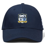 The 901 Rugby Retro Trucker Cap by EMB Alpha Broder features an embroidered "901 Rugby" logo and "Germantown TN" text on the front, complemented by a navy blue design and a snapback closure for the perfect fit.
