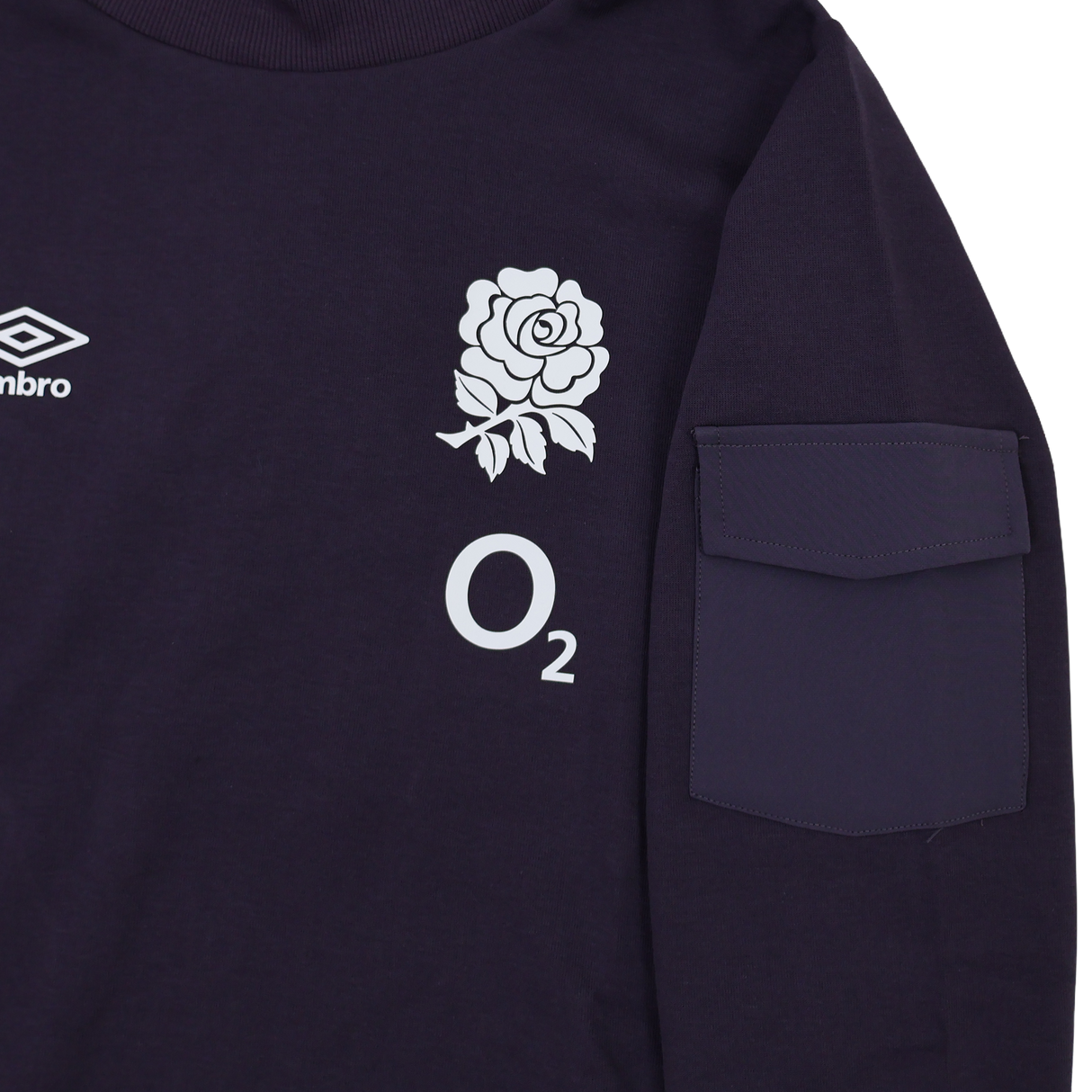 A close-up of the Women's England Presentation OH Hoodie 24/25 by Umbro, branded by Castore, showing a dark design with an Umbro logo, white rose emblem, "O2" text, and a right sleeve pocket.