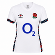 The Women's England Home Replica Jersey 24/25 by Umbro for Castore features short sleeves, a white base, blue O2 sponsor logo, red rose emblem, and navy/red stripes on the sides and sleeves; Women's Rugby Jersey.