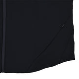 Close-up of the lower side section of the black Ireland 25/26 Travel Hoodie by Canterbury, featuring a zipper on the left and a small zippered pocket on the right side.