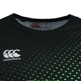 Close-up of the Teamatical CANTERBURY ECO SUBLIMATE SS RAGLAN TEE - MENS in black with a green dotted pattern, moisture-wicking fabric, and "Large" size label and logo visible inside the collar.