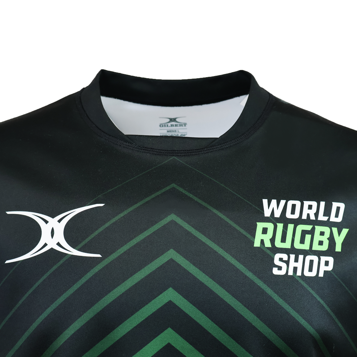 The Gilbert Sublimated Pro Jersey - Mens by Teamatical is a black rugby jersey with green geometric patterns, featuring the "World Rugby Shop" logo and a white stylized "X" on the chest.