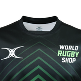 The Gilbert Sublimated Pro Jersey - Mens by Teamatical is a black rugby jersey with green geometric patterns, featuring the "World Rugby Shop" logo and a white stylized "X" on the chest.