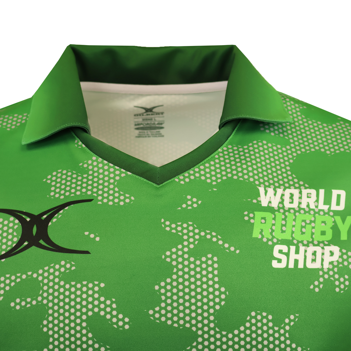A close-up of the Gilbert Sublimated Pro Collared Jersey - Mens by Teamatical, featuring a green pixelated pattern, black logo on the left chest, and "WORLD RUGBY SHOP" text on the right.