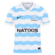 White short-sleeved Racing 92 26/27 Stadium Home Jersey by Nike featuring light blue wavy horizontal stripes, sponsor logos, and team branding on the chest.