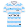 White short-sleeved Racing 92 26/27 Stadium Home Jersey by Nike featuring light blue wavy horizontal stripes, sponsor logos, and team branding on the chest.