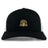The EMB S&S Activewear Arrows Rugby Club 10th Anniversary Retro Trucker Cap is a black and white hat with a gold-accented circular embroidered front design and snapback closure.