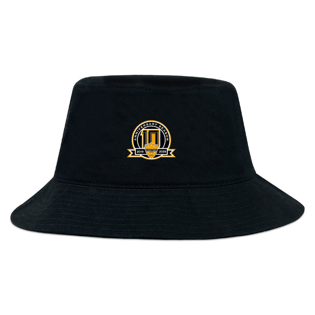 The Arrows Rugby Club 10th Anniversary Crusher Bucket Cap by EMB S&S Activewear features an embroidered yellow and black crest logo with text and a shield—stylish sun protection for any occasion.