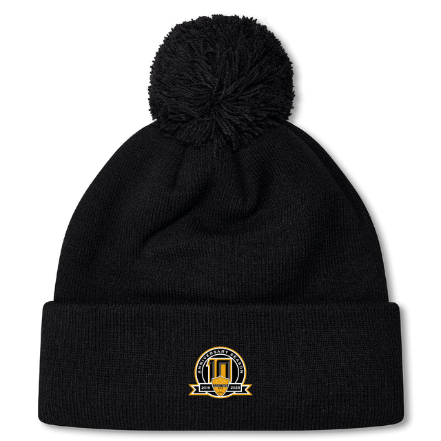 Stay warm on chilly match days with the Arrows Rugby Club 10th Anniversary Pom Pom Beanie by EMB Canterbury—a black knit, fleece-lined hat featuring a gold and black logo patch and cozy pom-pom.