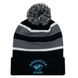 The EMB Augusta Nations of Rugby Argentina Hooped Pom-Pom Beanie features black, grey, and white stripes, a front cuff with blue "Argentina Rugby" and jaguar logo embroidery—ideal for rugby fans.