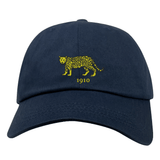 Nations of Rugby Argentina Vintage Dad Cap in navy blue, featuring a yellow leopard graphic and the year 1910 embroidered on the front, by EMB Alpha Broder.