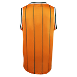 The Wallabies "Harlem" Basketball Singlet by Ashtabula is a sleeveless orange jersey with thin black vertical stripes and black-and-white trim on the armholes and collar, shown from the back.