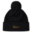 The Arrows Rugby Club Pom Pom Beanie by Canterbury features a black knit, fleece lining, and yellow "Arrows Rugby" logo embroidered on the fold—a cozy EMB Canterbury hat with pom-pom for fans.