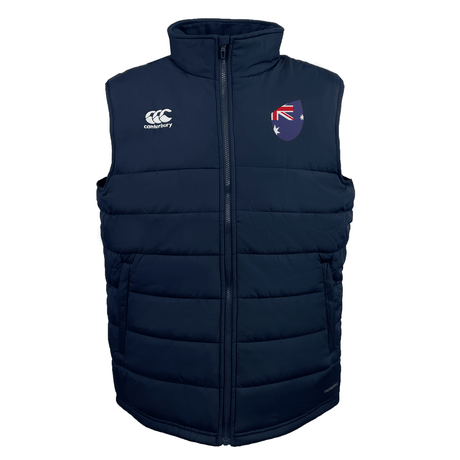The Australia Shield Core Gilet by EMB Canterbury is a navy blue puffer vest featuring Thermoreg insulation, a high neck, the Canterbury logo, and an embroidered shield with the Australian flag motif on the chest.
