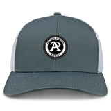The Atlanta Premier Rugby Club Retro Trucker Cap by EMB S&S Activewear features a gray and white design, a circular embroidered logo on the front, and a snapback closure.