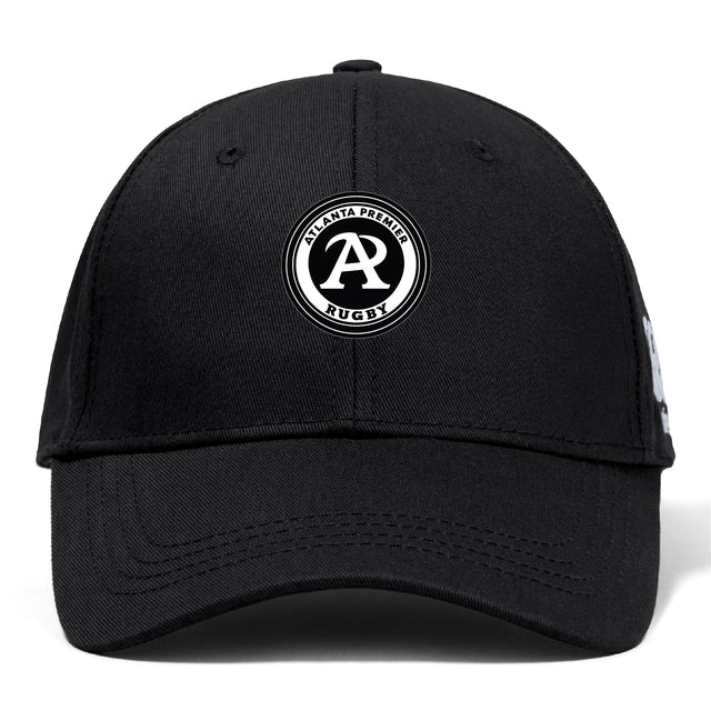 The Atlanta Premier Rugby Club Flexfit Drill Cap by EMB Canterbury is a black cap with a flex fit and an embroidered circular "Atlanta Premier Rugby" logo featuring a bold "A" on the front.
