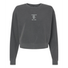 The EMB S&S Activewear Women's Amoskeag Rugby Club Mid-Length Crewneck Sweatshirt is a dark gray, relaxed-fit top with "AMOSKEAG Est. 1984" and a small white graphic on the chest, inspired by classic rugby club styles.