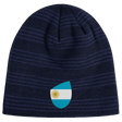 The EMB Canterbury Argentina Shield Beanie is a dark blue striped beanie with an Argentina flag patch featuring a sun emblem, offering warmth and national pride.