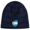 The EMB Canterbury Argentina Shield Beanie is a dark blue striped beanie with an Argentina flag patch featuring a sun emblem, offering warmth and national pride.