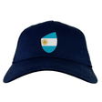 The Argentina Shield Flex Drill Cap by EMB Canterbury is a dark blue cap featuring a shield with the Argentine flag on the front, perfect for rugby supporters.