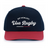The EMB Augusta USA Rugby Elevated 1975 Eagles Snapback Cap features navy blue and red colors with "EST MCMLXXV Usa Rugby" in white script, ideal for fans who love vintage style and rugby tradition.