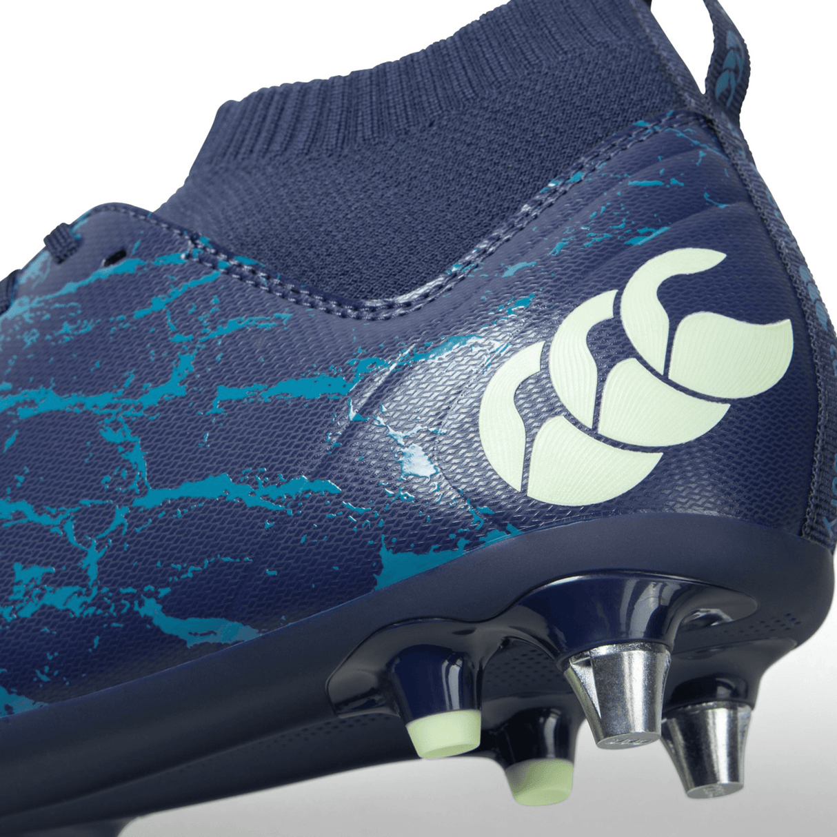 A close up of a blue and green rugby boot with exceptional traction, the Canterbury Stampede Pro SG - Medieval Blue/Blue Sapphire.