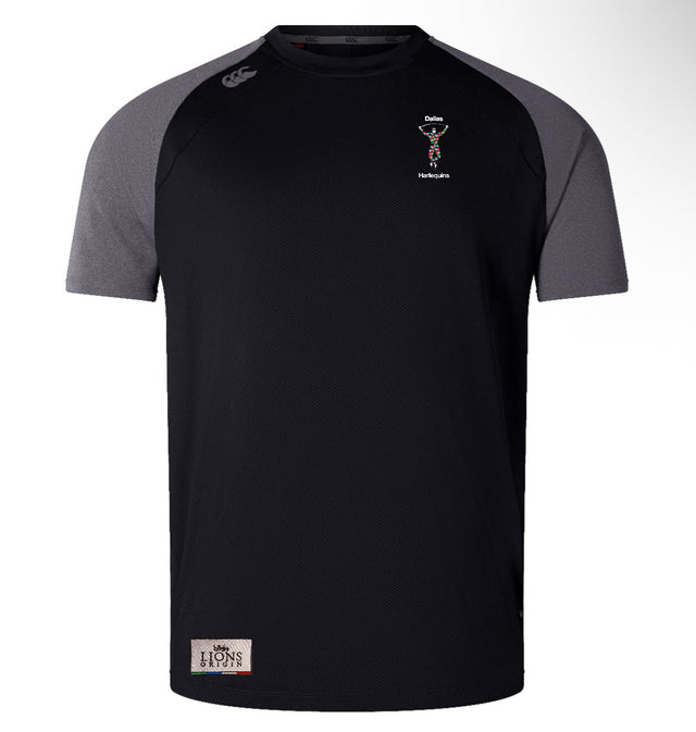 Lightweight and durable, the Dallas Harlequins Lions Origin Elite Training Tee by EMB Canterbury is a black short-sleeve athletic shirt with dark gray shoulders, small chest logos, and a rectangular patch near the bottom hem.