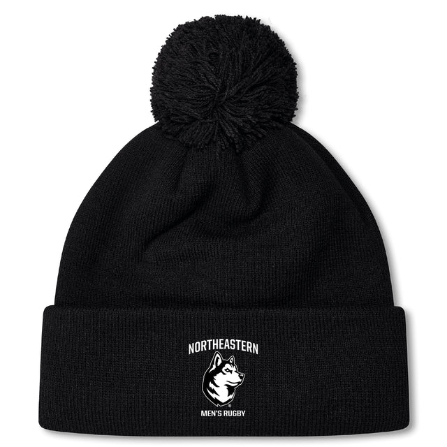 Stay warm and stylish with the Northeastern University Men's Rugby Pom Pom Beanie by EMB Canterbury, featuring a fleece lining, "Northeastern Men's Rugby" text, husky logo on the front cuff, and a classic pom-pom.