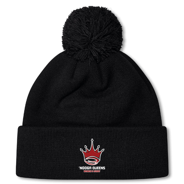 The Chattanooga Queens Rugby Pom Pom Beanie by EMB Canterbury is a black knit beanie with a pom-pom, fleece lining for warmth, and an embroidered red crown logo above the words "Noodga Queens Kapamilya Queens.