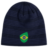 A navy blue beanie with dark stripes, featuring a patch showcasing a stylized Brazil Shield design by EMB Canterbury.