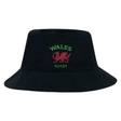 Show your Wales pride with the EMB S&S Activewear Nations of Rugby Wales Rugby Crusher Bucket Hat, featuring black cotton twill, "Wales Rugby" text, and a red Welsh dragon embroidered on the front. Perfect for devoted rugby fans!.