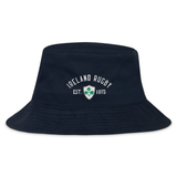 The Ireland Rugby 1875 Crusher Bucket Hat by EMB S&S Activewear features navy blue cotton twill with "Ireland Rugby Est. 1875" and a green shamrock crest embroidered on the front—ideal for any Irish rugby fan.