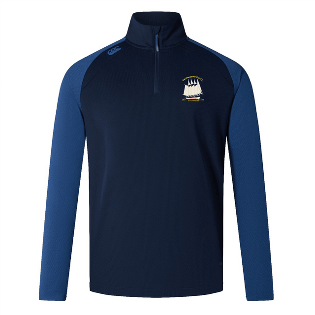The Cal Maritime Rugby Elite First Layer by EMB Canterbury is a navy and royal blue quarter-zip training top featuring a sailing ship logo on the left chest, small right shoulder logo, and VapoDri tech for workout comfort.