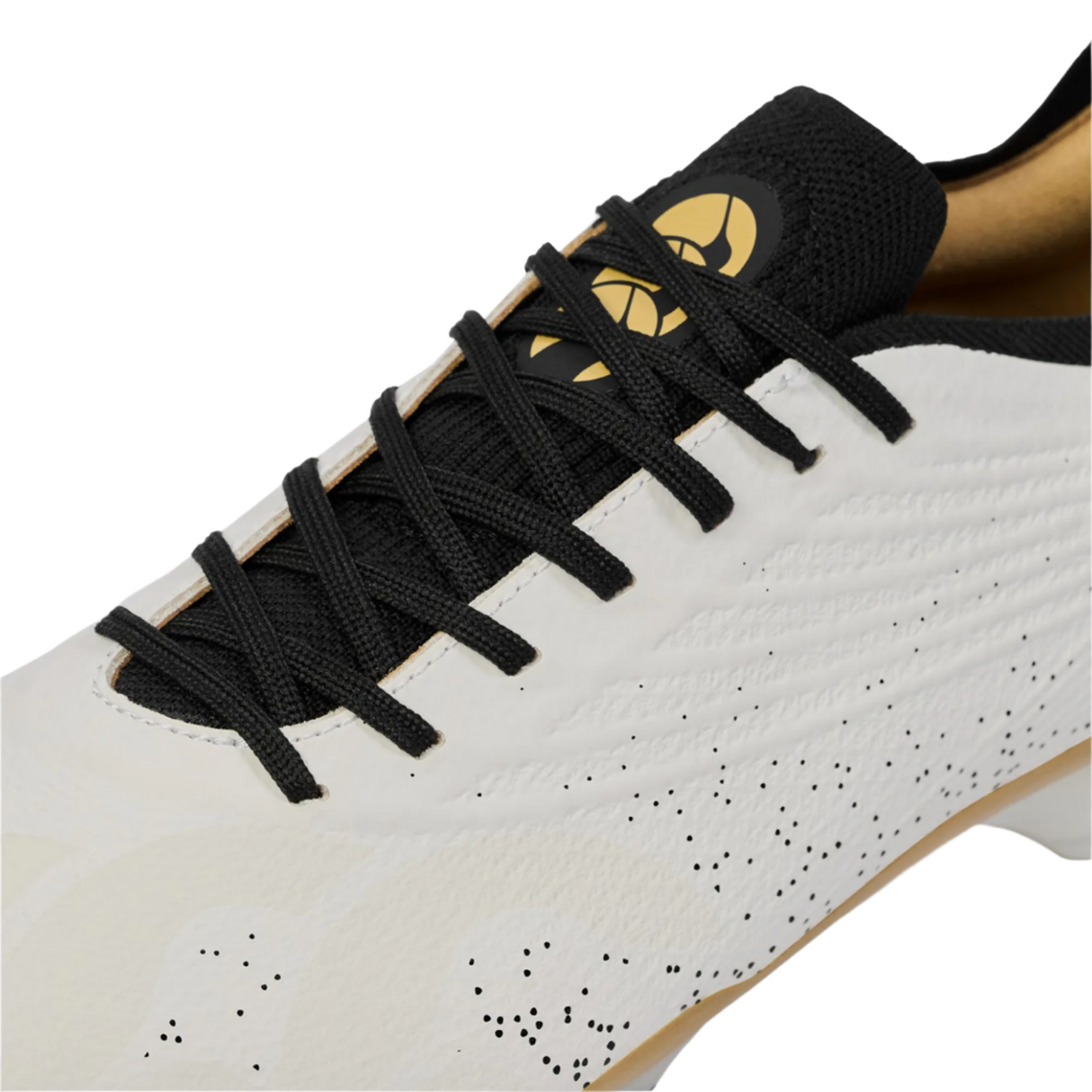 Close-up of the Canterbury Stampede Groundbreak Elite SG rugby boot by Canterbury in white, featuring black laces, a textured upper, and a gold and black logo on the tongue.