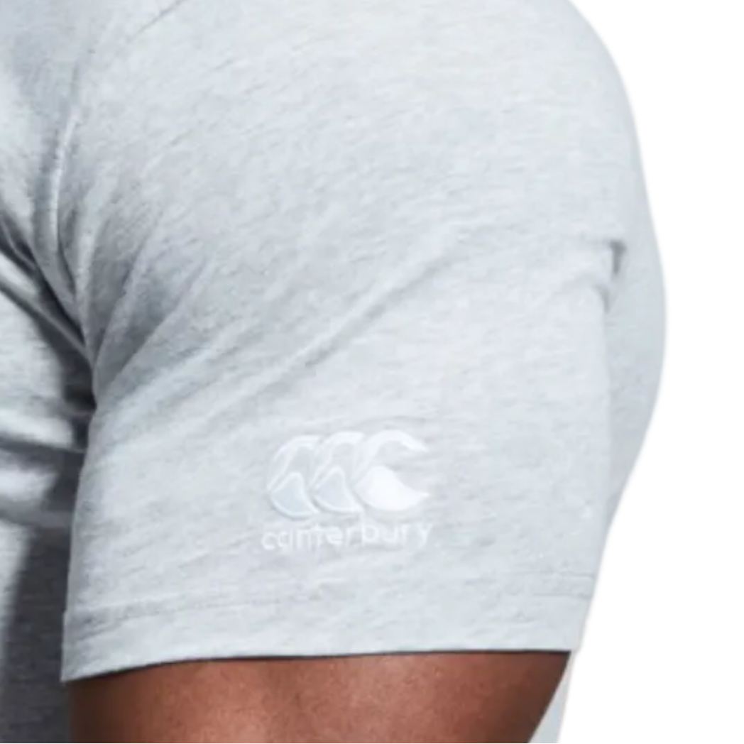 Close-up of a person’s arm wearing the light grey Canterbury Pennsylvania CCC Flag Club T-shirt by WRS Canterbury, featuring a white Canterbury logo on the sleeve and expressing subtle rugby state pride.