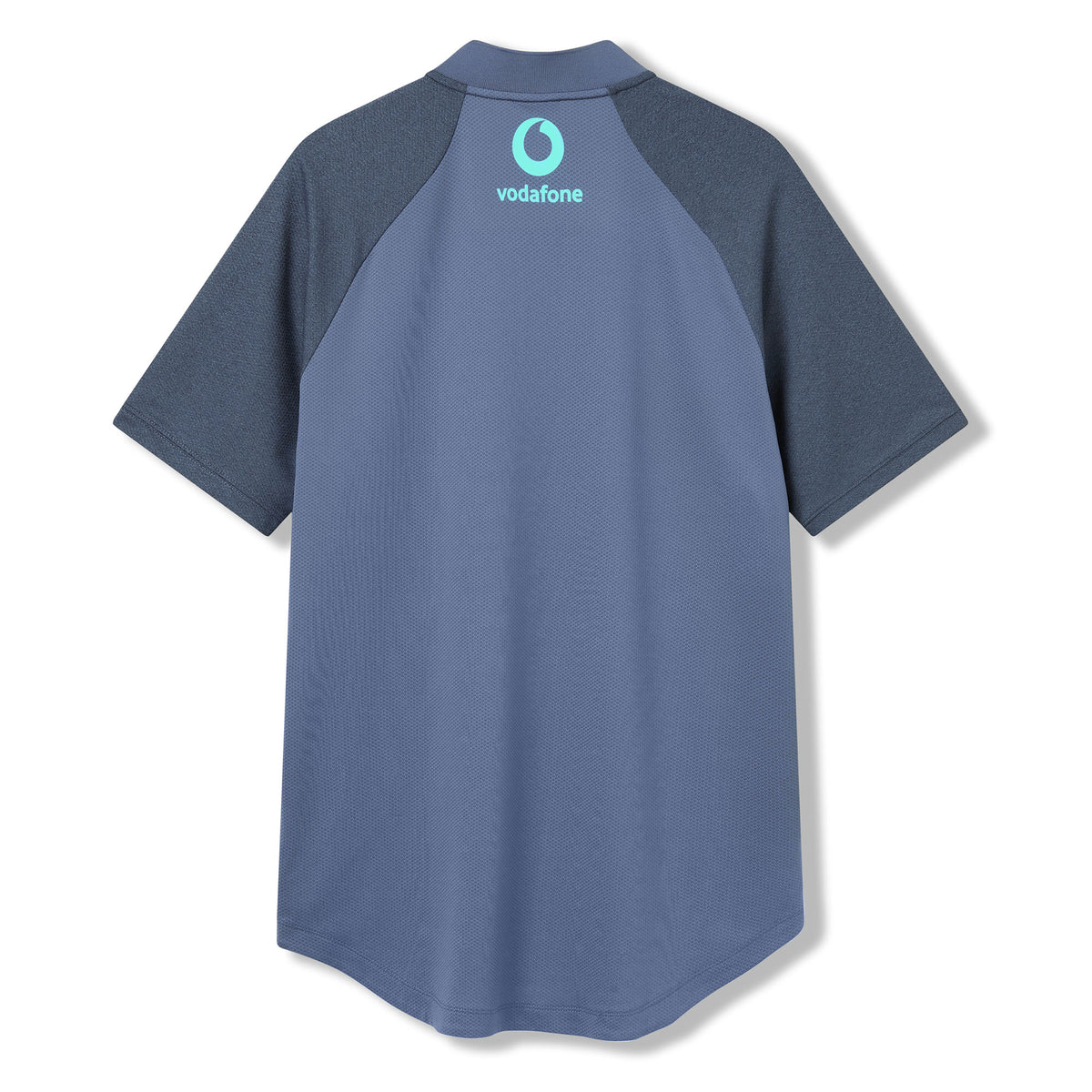 The Ireland 26 Poly Polo by Canterbury is a short-sleeved blue polo featuring dark blue sleeves and a light blue Vodafone logo on the upper back, designed in the classic style of an Ireland rugby polo.