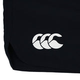 Close-up of the lower part of the Women’s Ireland 26 6″ Woven Gym Short by Canterbury in black, featuring a white Canterbury logo with three overlapping shapes, typically seen on women’s athletic shorts.