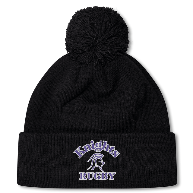 A black knit Ardrey Kell Rugby Pom Pom Beanie by Canterbury with a pom-pom on top. "Knights Rugby" and a knight's helmet are embroidered in white and purple on the folded cuff, making it perfect for Canterbury Rugby fans.