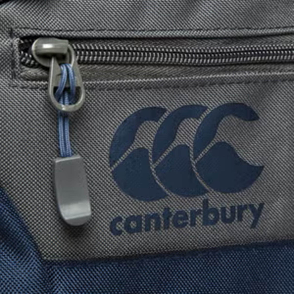 Close-up of the Canterbury Classic Bootbag in gray and blue, featuring a zipper and the "Canterbury" logo printed beside it, crafted with Vaposhield technology for enhanced durability and water resistance.