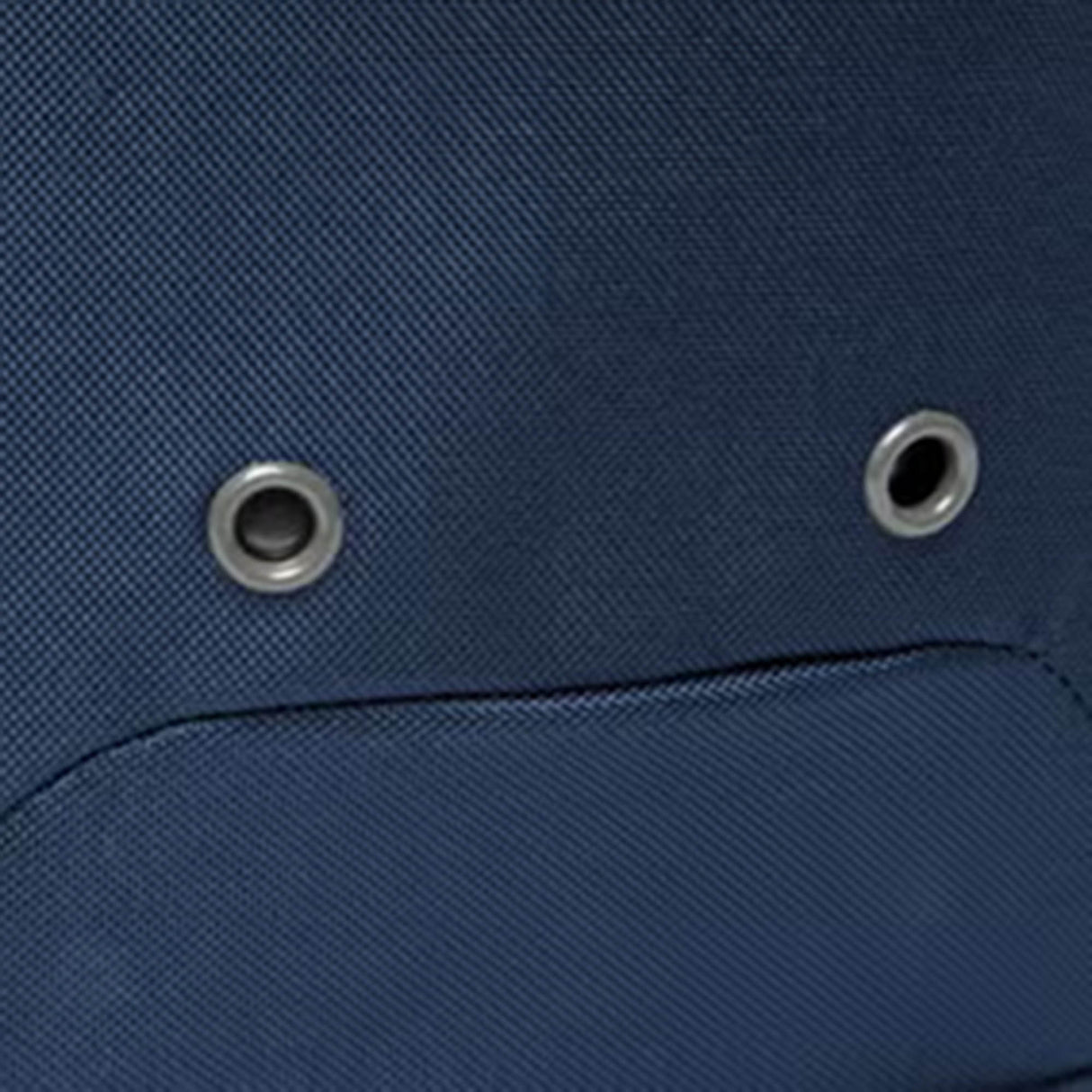 Close-up of a blue fabric surface with two metal grommets and a horizontal seam below them, highlighting Vaposhield technology as featured in the Canterbury Classic Bootbag by Canterbury.