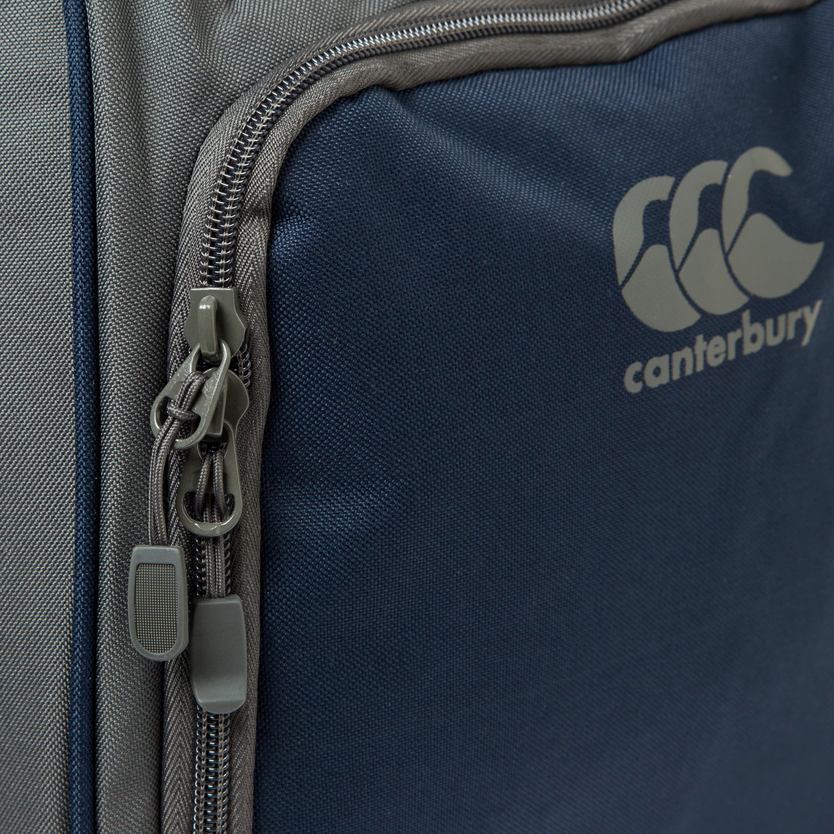 Close-up of the Canterbury Holdall Duffle Bag by Canterbury, showcasing water-repellent fabric, a zippered pocket with dual pulls, and the iconic logo—ideal for rugby fans.