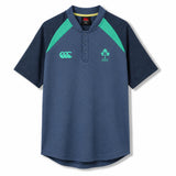 The Ireland 26 Poly Polo by Canterbury features a navy blue design with green accents, a buttoned collar, and embroidered chest logos—this timeless piece from Canterbury is inspired by classic Ireland rugby polos for an authentic athletic style.